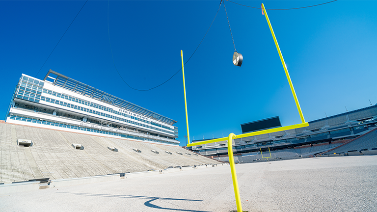 Football goal post with a football going through it