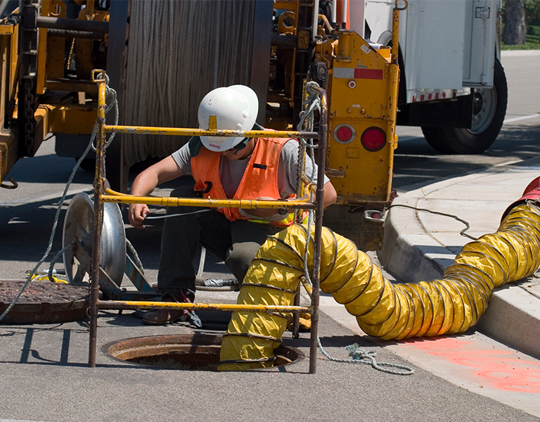 Public workers on sewer