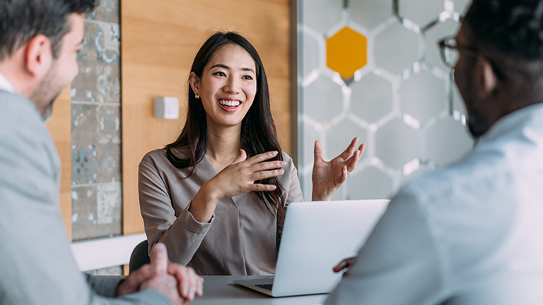 Woman talking with two co-workers