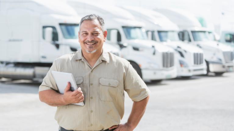 Man standing in front of trucks