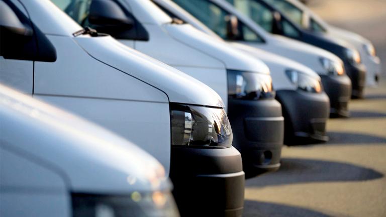 side image of a row of parked matching vehicles from a city fleet