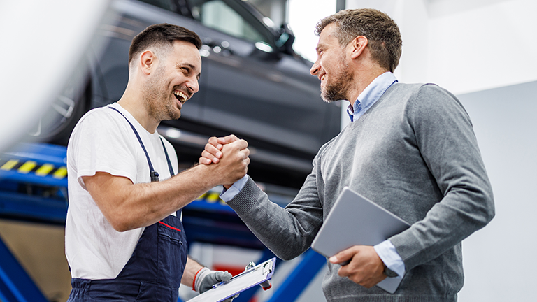 A fleet worker and supplier shaking hands