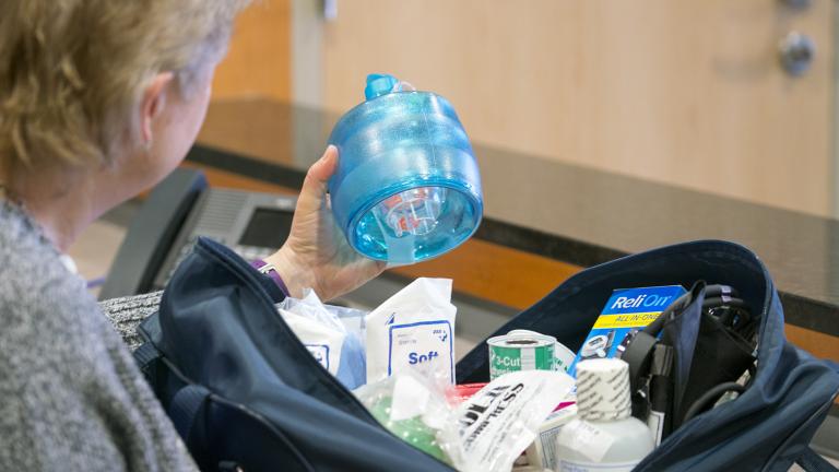 a woman inspecting a first aid kit