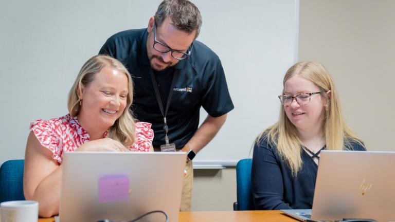 three adults working together
